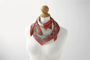 Detail of vintage red silk scarf with intricate sunflower and floral patterns on a mannequin