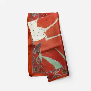 Macro view showing silk texture and oriental deer pattern on a red fashion scarf