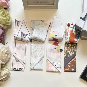 Detail showing four assorted satin twilly scarves with butterfly and floral patterns