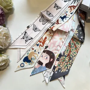 Flat lay of colorful printed polyester twilly scarves with diverse patterns and floral props