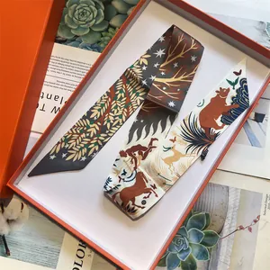 Close-up of animal pattern silk twilly scarf elegantly placed in a classic orange gift box