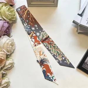Detailed view of forest animal print twilly scarves with deer and star patterns