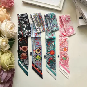 Detailed macro view of four floral pattern twilly silk scarves for hair and bags
