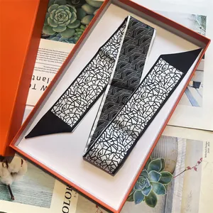 Elegant black and white geometric silk skinny scarf in signature orange gift box