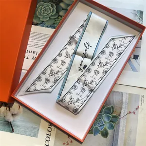 Elegant grey floral silk twilly scarf with yourself text in an orange gift box