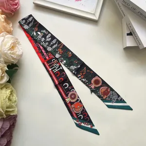 Detail of double-sided twilly scarf featuring floral prints and equestrian motifs