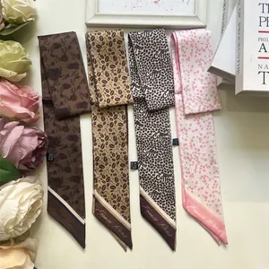Close-up of elegant French style skinny silk scarves with coffee bean patterns and prints