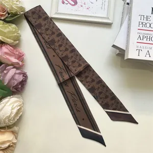 Macro detail of brown coffee pattern silk twilly scarf with French Paris lettering