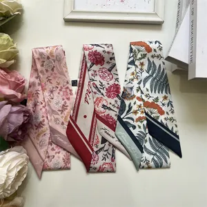 Detailed macro of three floral silk twilly scarves with France Paris elegant patterns