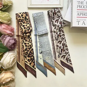 Three elegant leopard and floral silk scarves with Paris text on a stylish background