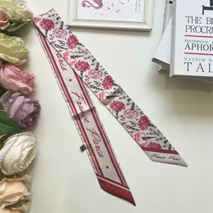 Detail of floral silk scarf with France Paris lettering and delicate flower patterns