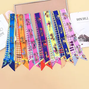 Macro view of assorted silk twilly scarves with vintage carriage patterns for handbags