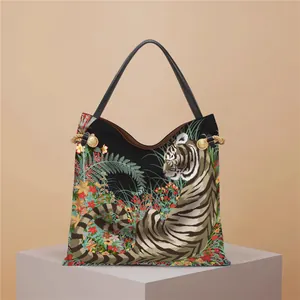 Detailed tiger print on a canvas tote bag featuring lush jungle flowers and golden accents