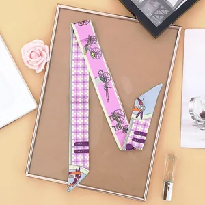 Macro view of twill silk scarf with horse carriage print and pink plaid pattern