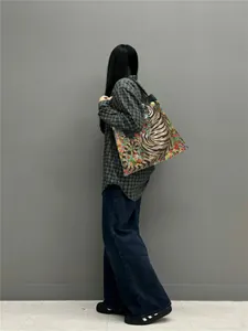 Artistic tiger and floral print tote bag shown on model side view for size reference
