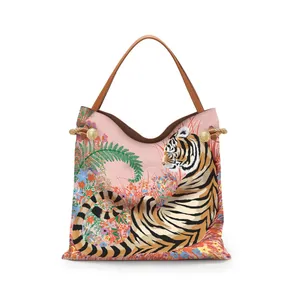 Detailed close-up of pink tiger tote bag with tropical flower patterns and brown handles