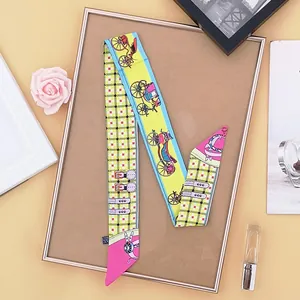 Detail of colorful twilly scarf with horse carriage and check pattern on display board