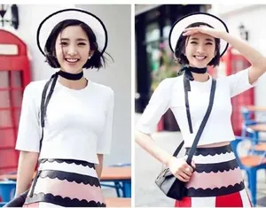 Detailed view of women's narrow solid silk scarf styled with a white T-shirt and skirt