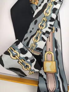 Close-up of zebra pattern silk scarf with golden chain print and twill texture