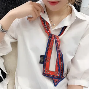 Narrow silk scarf with red, white and blue floral pattern on 100% polyester fabric