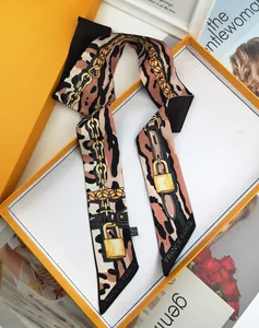 Leopard print twilly scarf with chain patterns and luxury orange gift box packaging