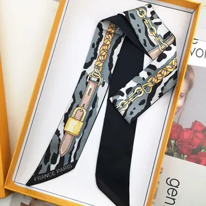 Elegant leopard print silk scarf with golden chain patterns in a luxury gift box packaging