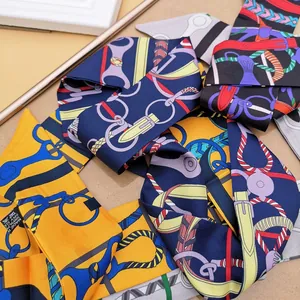 Detail of silk twilly scarf showing equestrian prints and 100% silk material label
