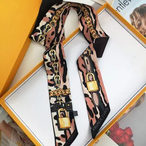 Elegant leopard and chain print silk scarf in an orange gift box with fashion magazine