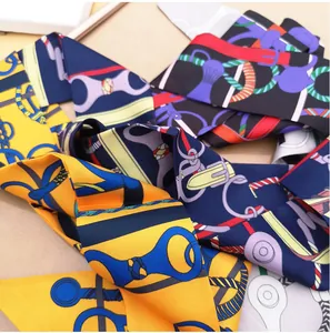 Detail shot of silk scarves with horse bridle patterns for bag handles and hair accessories