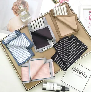 Detailed view of striped skinny silk scarves neatly folded in a decorative tray