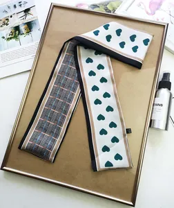 Detail of double-sided silk scarf with heart and plaid patterns and Made in China tag