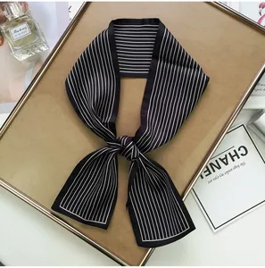 Close-up of black and white striped silk twilly scarf with elegant satin finish