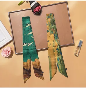 Close-up of silk twilly scarves featuring Chinese crane and landscape oil painting patterns