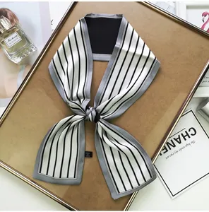 Detail of a thin striped silk scarf tied elegantly with soft texture and chic gloss finish