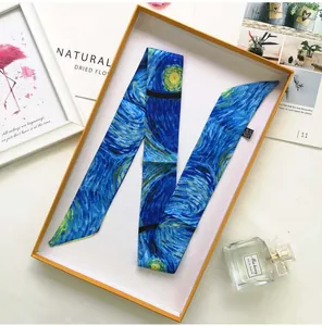 Artistic Van Gogh Starry Night silk ribbon scarf elegantly displayed in a gift box with props