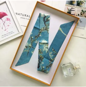 Close-up of Van Gogh Almond Blossom print silk twilly scarf in elegant gift box