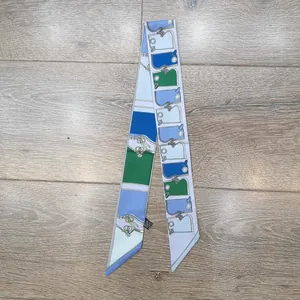 Detail eines Seidenschals mit Handtaschen-Mustern auf einem hölzernen Hintergrund