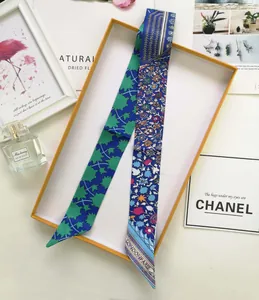 Detailed view of floral silk scarf handle wrap presented in a stylish gift box
