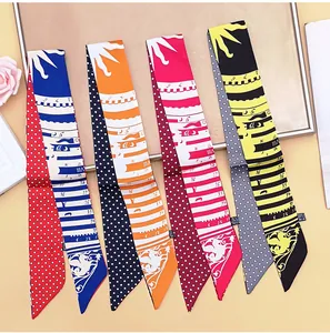 Detail of four narrow satin scarves with elegant patterns for handbag handle decoration