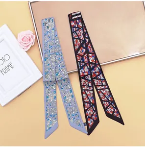 Detailansicht von blauen und schwarzen Seidenschals mit geometrischen Hausmustern für Taschen