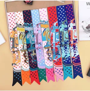 Close-up of multicolored silk twilly scarves with heart and equestrian prints on display