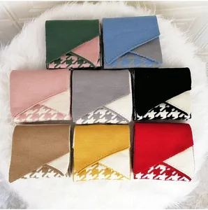 Flat lay display of 8 colorful knitted scarves with houndstooth pattern on soft plush