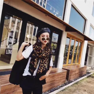Classic leopard print scarf styled with a white T-shirt and black beret for an urban look