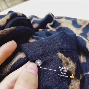 Detailed close-up of leopard print scarf featuring premium stitched edges made in Korea