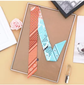 Detail of a paisley silk scarf tied on a frame with elegant lifestyle accessories