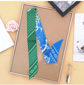 Detail of a blue and green paisley print skinny scarf styled on an aesthetic vanity setup