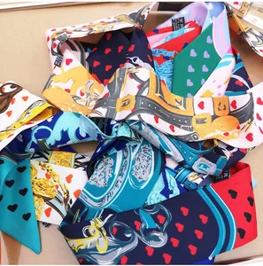 Detail showing various printed silk twilly scarves with heart and baroque patterns