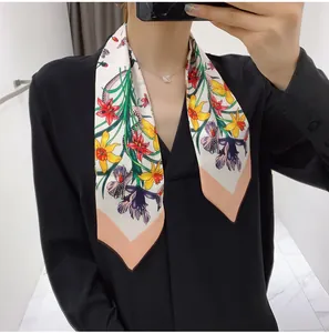 Floral silk-like twill scarf styled as a versatile necktie on a black shirt
