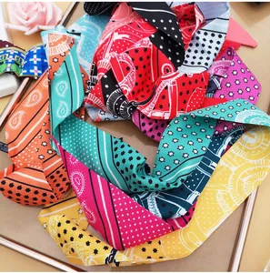 Detailed flat lay of colorful paisley pattern polyester skinny scarves and ribbons