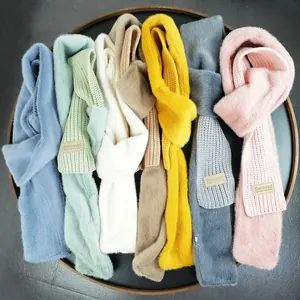 Colorful knitted rabbit fur scarves with Beloved leather patch in seven vibrant colors